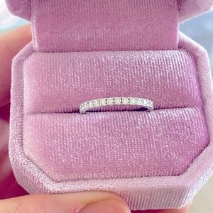 Moissanite and 14k white gold eternity wedding band. Size 8.